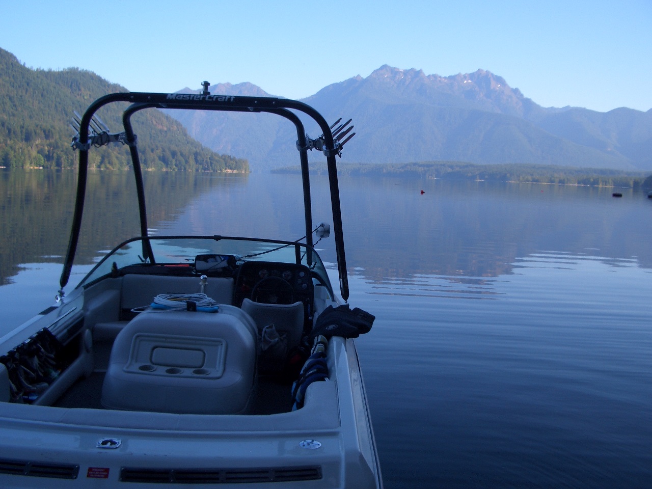 Wakeboard boat on lake with great view of the Olympic Mountains