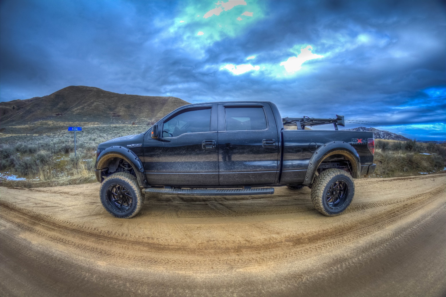 Lifted black for F-150 on a dirt road